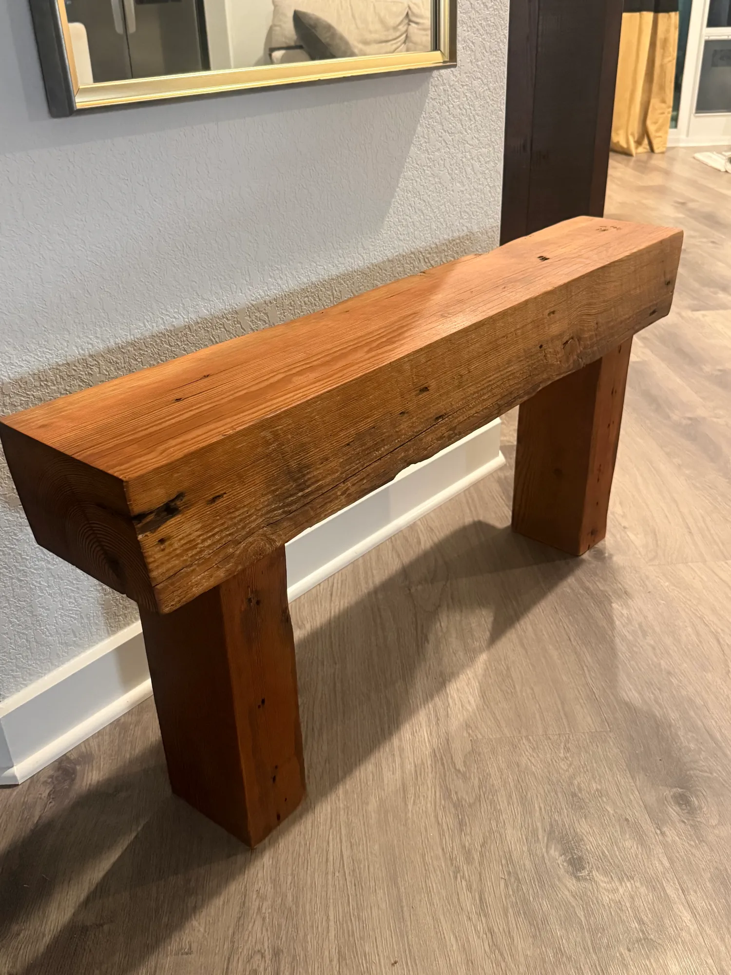 Reclaimed beam bench in a client's entryway