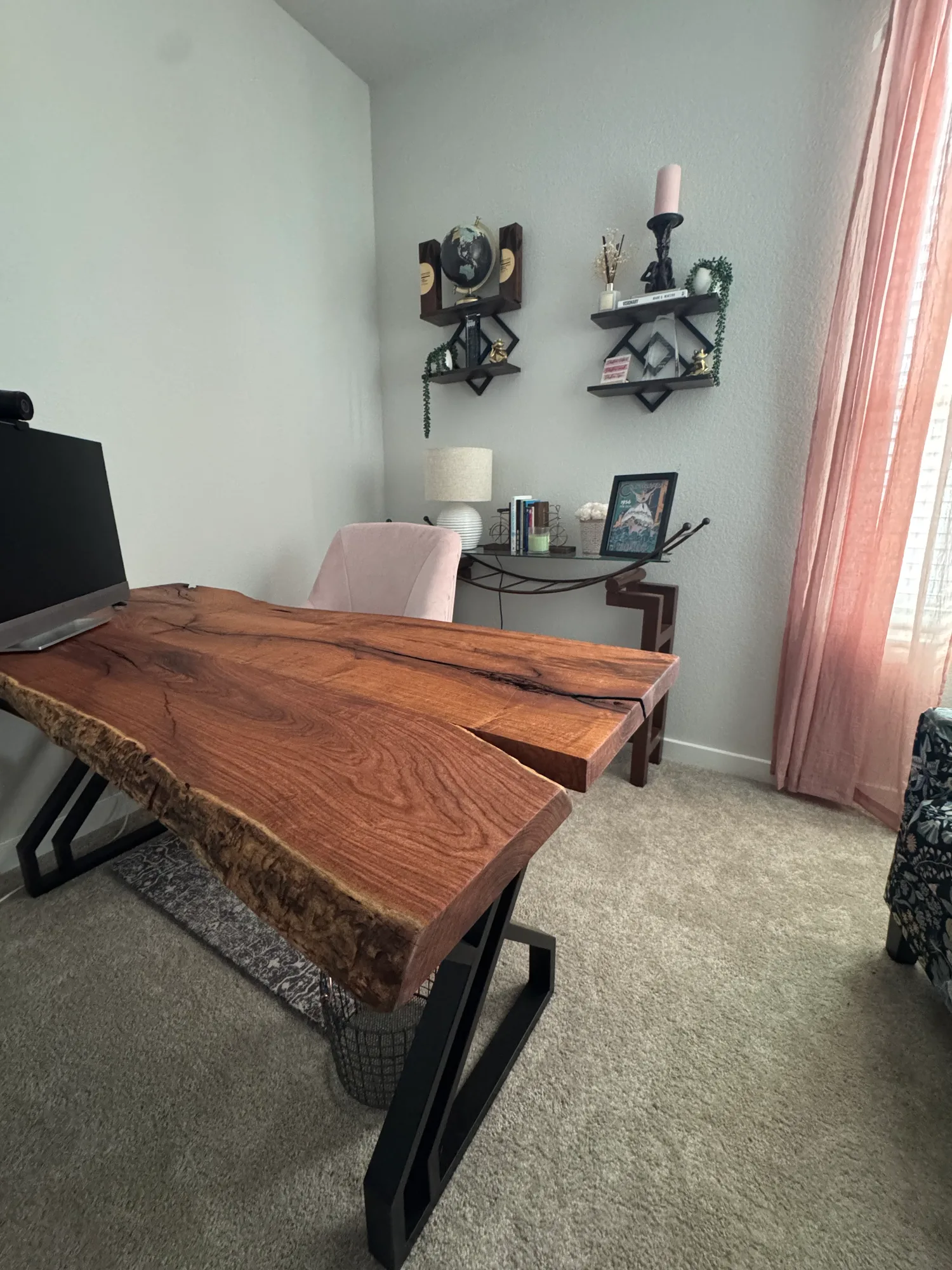 Custom live-edge slab desk on black steel legs in a bright home office