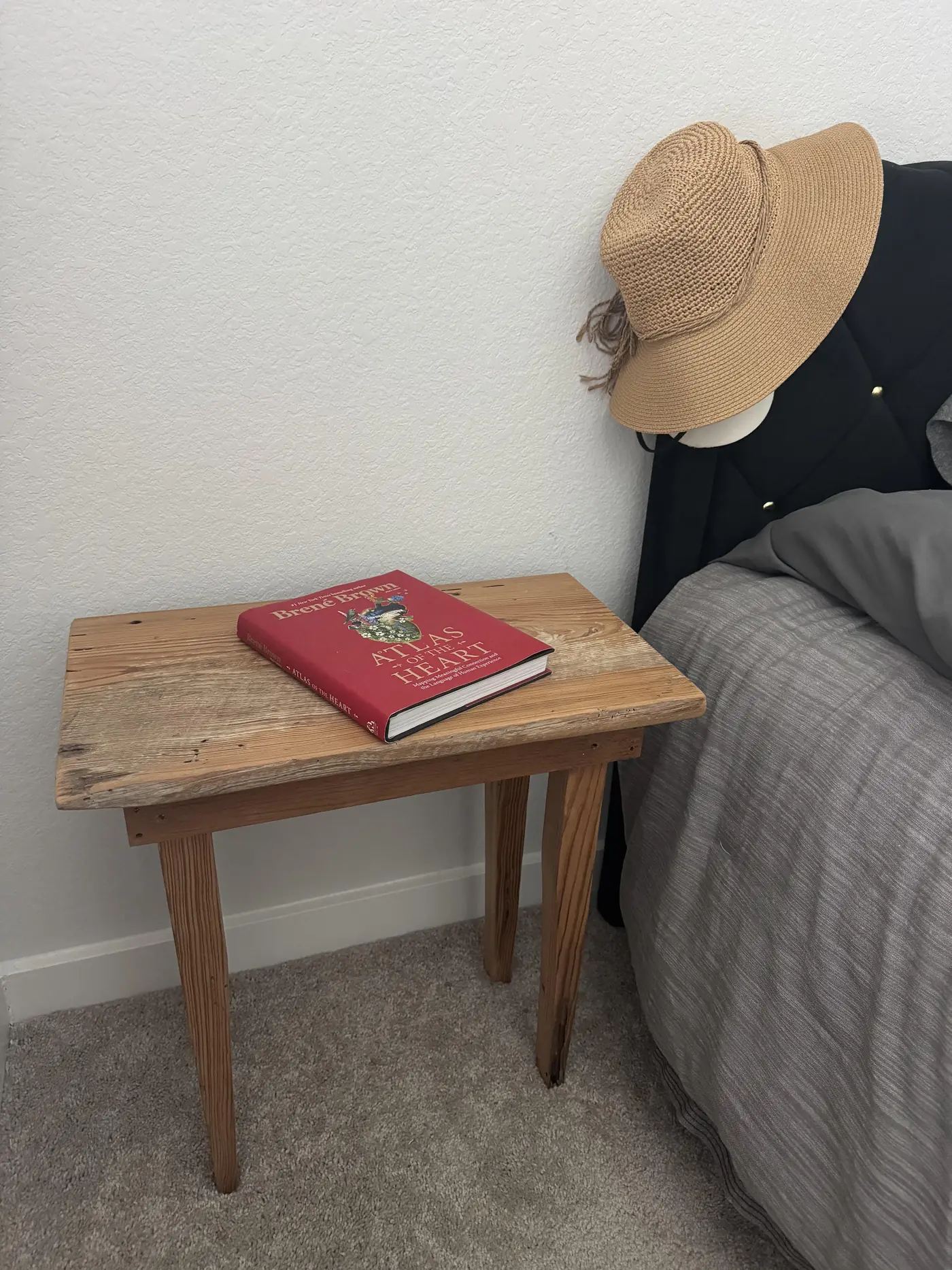 Reclaimed longleaf pine night stand beside a bed in a client's home
